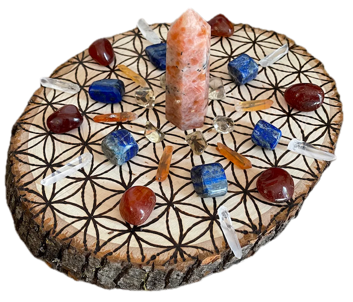 A crystal grid with a sunstone tower featuring natural citrine, lapis lazuli, tangerine quartz, carnelian, and clear quartz